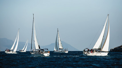Naklejka na ściany i meble Luxury yachts at Sailing regatta. Sailing in the wind through the waves at the Sea.