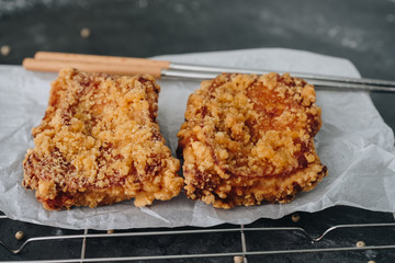 Chicken karaage japanese food in the tray with chopsticks on grey concrete background with herb and flour