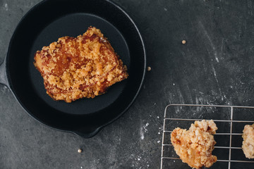 Chicken karaage japanese food in the tray on grey concrete background with herb and flour