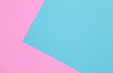 Blue and pink pastel color papers geometric flat laying.