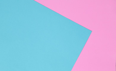 Blue and pink pastel color papers geometric flat laying.