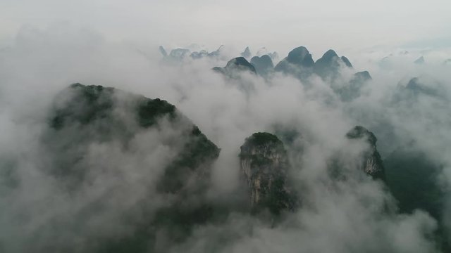 aerial view of Karst mountains and village with beautiful cloudscape. Located near Yangshuo County, Guilin City, Guangxi Province, China.