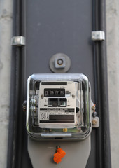 Fototapeta premium Closeup of outdoor electricity watt meter at the pole. Vertical view. 