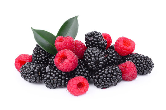 raspberries and blackberries with green leaf isolated on white background