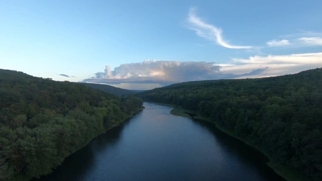 River, forest, and sky shot from above with a drone.