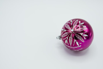 Silver and pink shiny christmas ball on white.