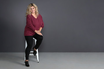 fat girl with a beautiful smile on a grey background