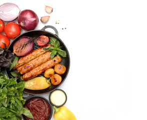 Grilled sausages for grilling in a pan. Isolated on white background. The view from the top.