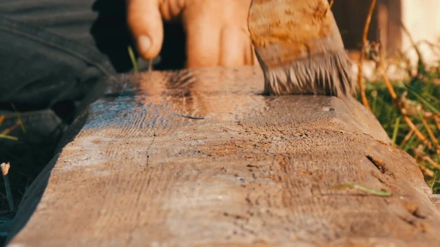 Wood painting with a brush with gray color