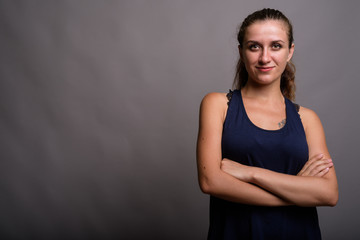 Portrait of young beautiful woman against gray background