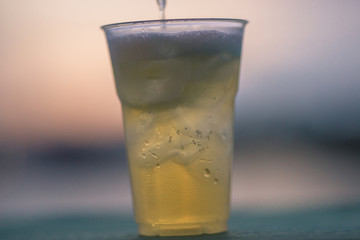 The background of ice cold water and soft drinks (soft drinks, beer, liqueurs, drinking water) has the vapor dispersed around the glass, a beautiful one, the colorful wallpapers of bubbles.