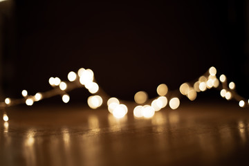 Abstract christmas lights on  black  background. Defocused  Glowing light bulb garland, copyspace