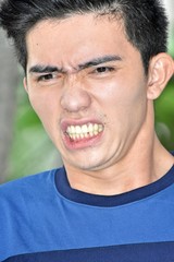 Fototapeta premium Stressed Young Asian Adult Male