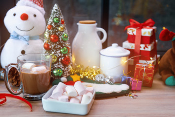 Hot chocolate with marshmallow for warming in Christmas holiday celebration.