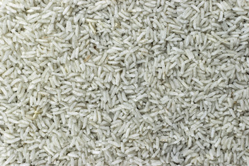 Background patter of white rice grains closeup