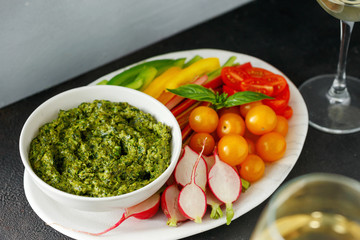 Top view Vegetable snacks pesto sauce close up