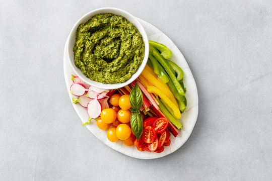 Top view Vegetable snacks with pesto sauce flat lya