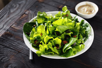 Bowl fresh green lettuce various lettuce leaves wooden table