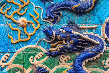 Nine Dragon Wall of marble carving of dragons playing with pearls at the Forbidden City palace of...