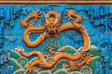 Nine Dragon Wall of marble carving of dragons playing with pearls at the Forbidden City palace of the emperors in Beijing China