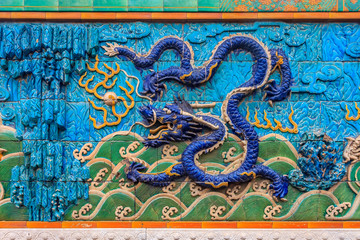 Nine Dragon Wall of marble carving of dragons playing with pearls at the Forbidden City palace of the emperors in Beijing China