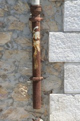 old rusty pipe on the wall