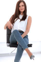 Fototapeta na wymiar young successful woman sitting in a chair