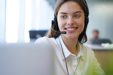 Customer support operator working in a call center office.