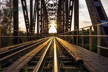 railway bridge and the sun at sunset