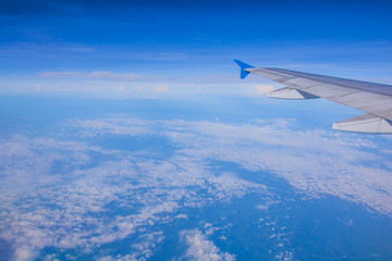 top view blue sky with wing of airplane