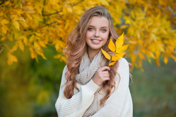 Beautiful girl walking outdoors in autumn.