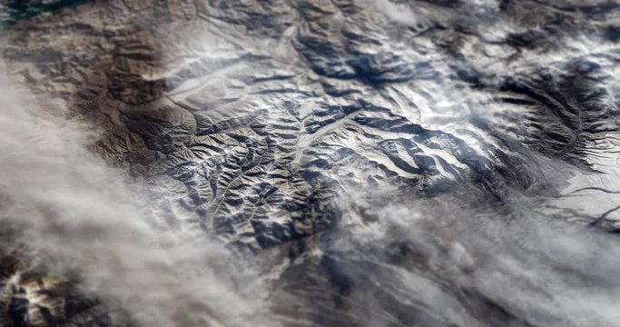 Very high-altitude circular tracking shot of Kamchatka Peninsula, Russia with tilt-shift effect. Reversible. Elements of this image furnished by NASA. 