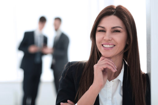 smiling business woman on blurred office background
