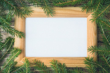 Creative layout made of Christmas tree branches with paper card note. Flat lay. Nature New Year concept.