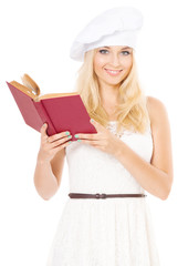 Woman in chef hat with cookbook, isolated on white background