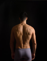 Fototapeta premium a man from behind in black background