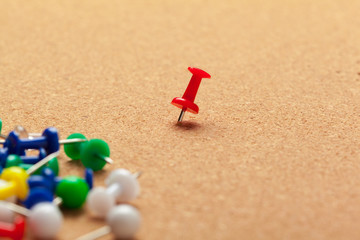 Group of thumbtacks pinned on corkboard close up. School or business concept