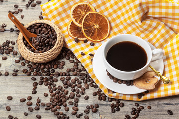 Cup Of Coffee And Coffee Beans On Table.