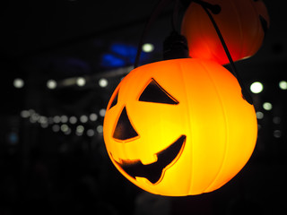 Halloween pumpkin head jack lantern with lighting over black background.