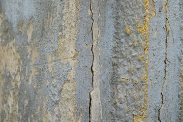 Obraz premium Old foundation and plaster wall with cracks. Building requiring repair closeup.