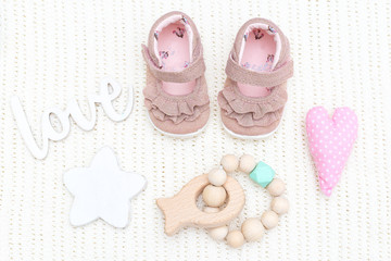 Obraz premium Baby shoes for girls and teether wooden