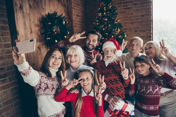 Cheerful full family showing two finger festure v-sign. Noel gat