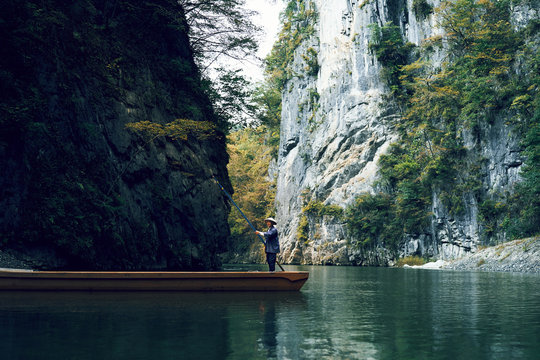 Man standing on raft in river