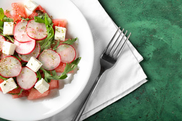 Plate with delicious watermelon salad on table