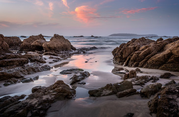 Fototapeta na wymiar Coastal rocks and reflections in dawn hours