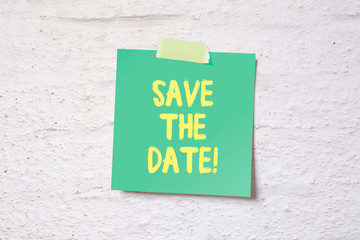 Save the date - memo pinned on white wall