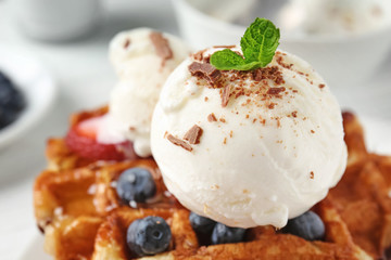 Delicious waffles with berries and ice cream, closeup