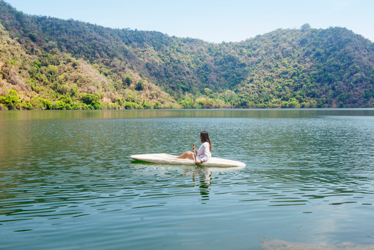 Asian lady paddling the kayak on the lake in satonda island