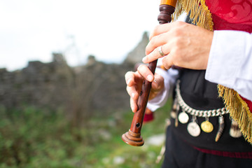 Bagpipe player detail. With traditional dress - obrazy, fototapety, plakaty