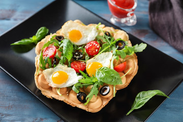 Delicious bubble waffle with fried eggs on plate